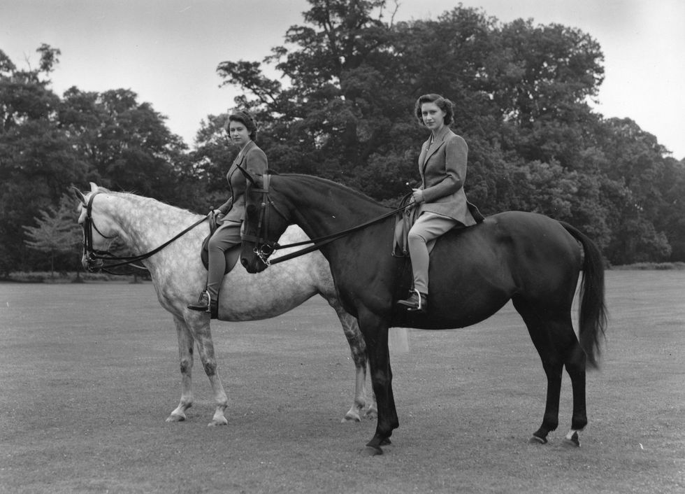 July 8, 1946 Princess Elizabeth (left) and Princess Margaret (right) riding in the grounds of the Royal Lodge, Windsor.