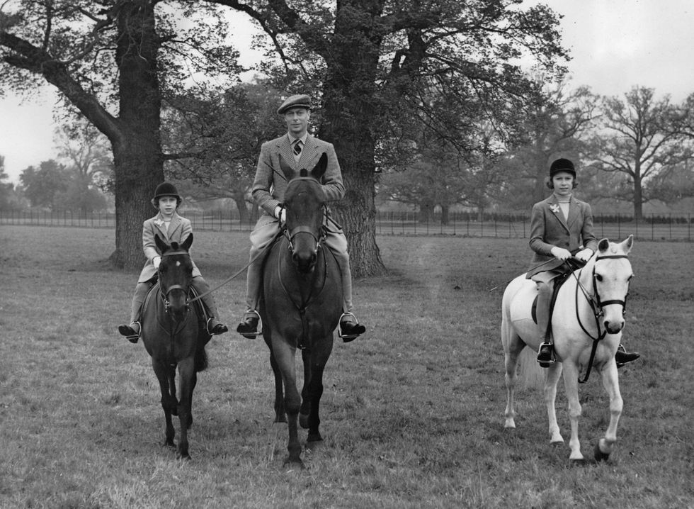 April 21, 1938 King George VI rides alongside Princess Elizabeth and Princess Margaret.