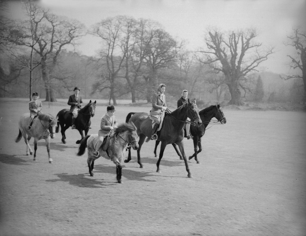 1956 The Queen on horseback with her children Princess Anne and Prince Charles.