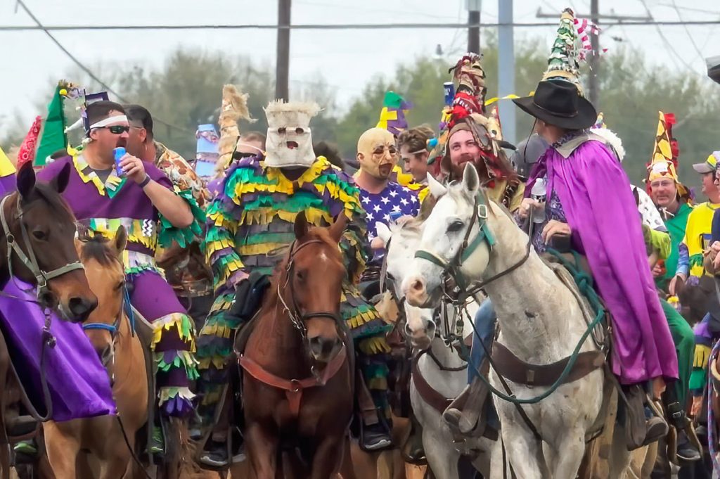 costumed riders on horseback Mardi Gras